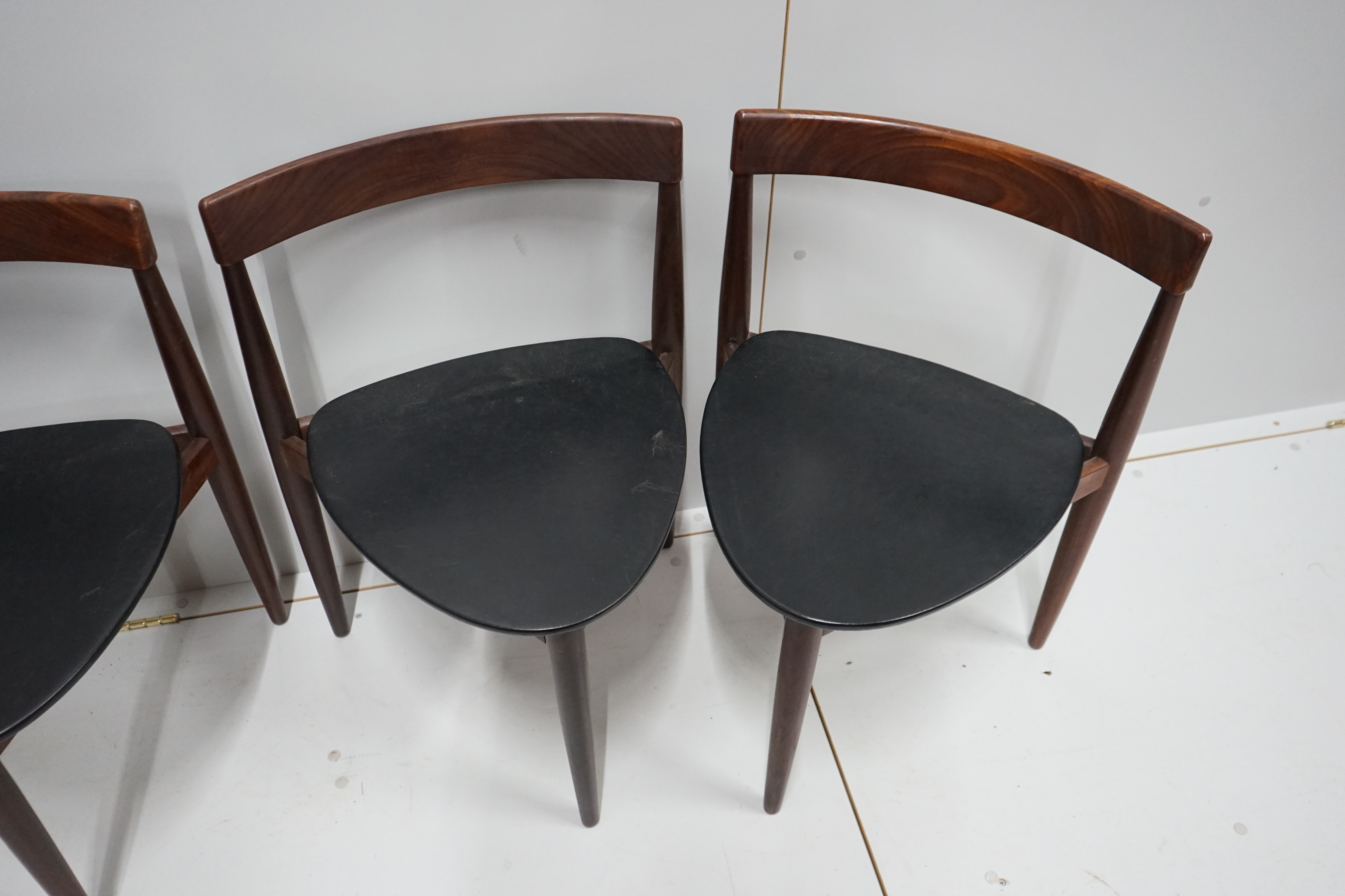 Hans Olsen for Frem Rotle, a set of four aphromosia tripod dining chairs, width 50cm, depth 41cm, height 71cm.